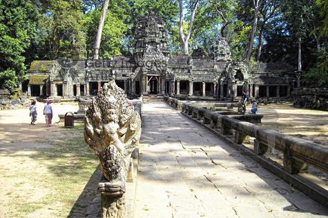 Tourists visit Ta Prohm - the legendary Tomb Raider temple covered with giant trees that have grown on ancient structures for more than 600 years.