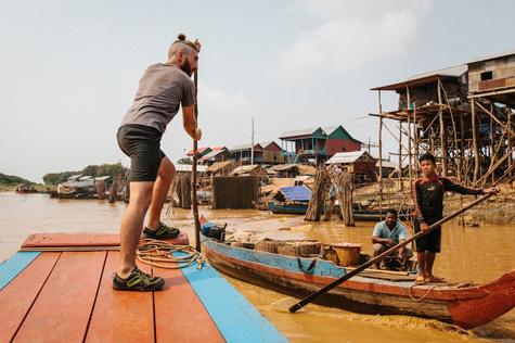 Visitors use a traditional wooden boat to set sail on the vast and breathtaking Tonle Sap Lake.